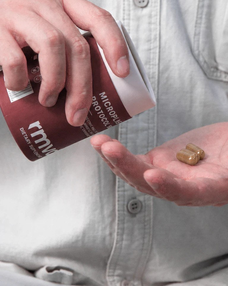 Man pouring rmvd capsules from the tube into his open palm
